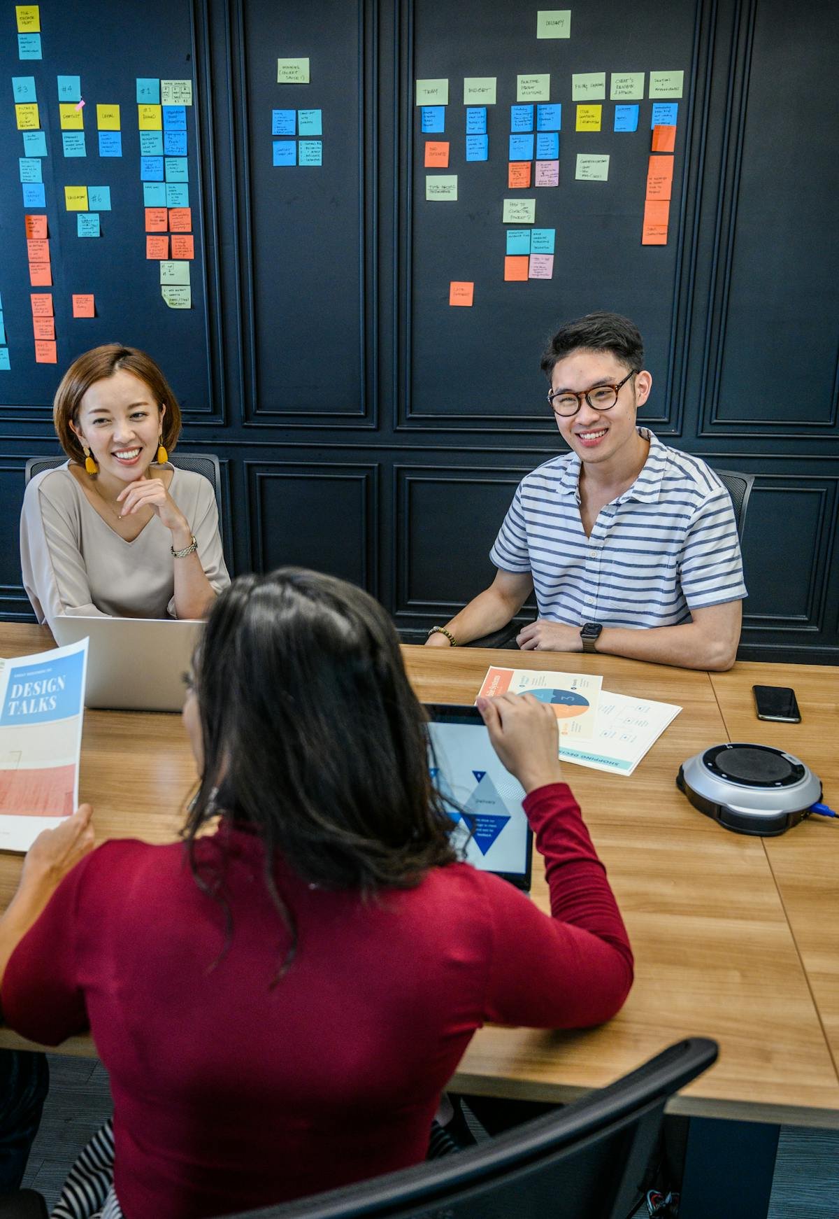 Corporate business meeting reviewing workflow notes and planning boards