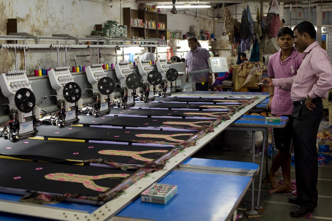 Indian industrial embroidery factory unit with manufacturing worktables